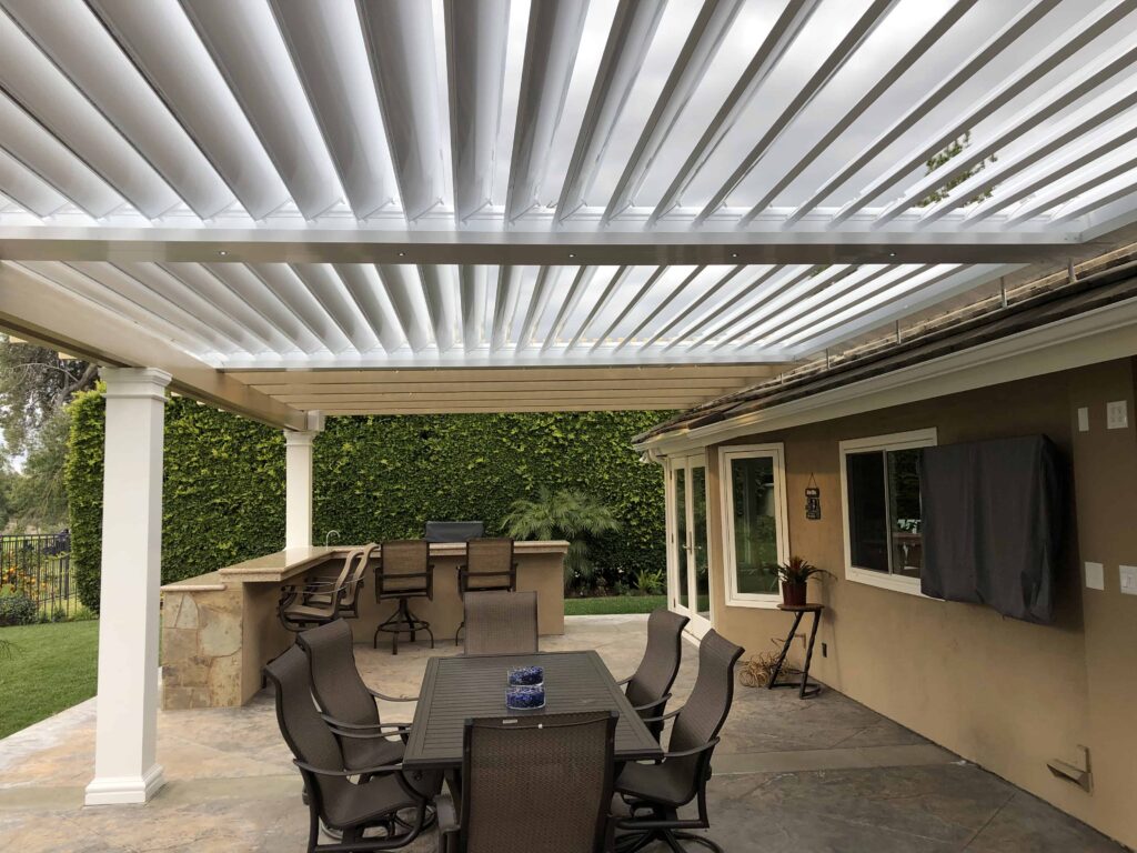 Equinox Louvered Patio Cover over a backyard dining area in Orange County, CA, with adjustable louvers for sun, shade, and ventilation