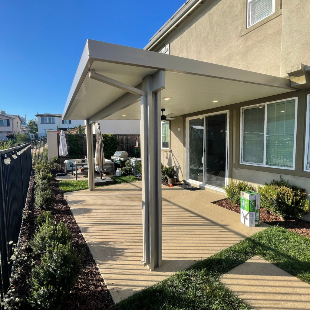 Stylish aluminum solid patio cover with wood-like finish enhancing backyard comfort and design