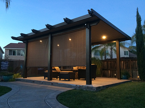 Custom free-standing patio cover in a backyard living area providing shade and stylish outdoor space in Orange County, CA